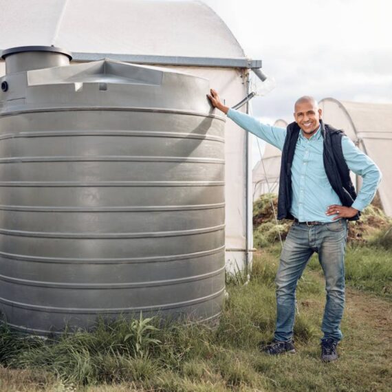 Man, portrait and water tank in farming liquid or soil hydration for vegetables, food and crops gro.